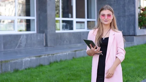 Young blonde working on tablet pc in city. Female using wireless internet on the Video stock 94191008