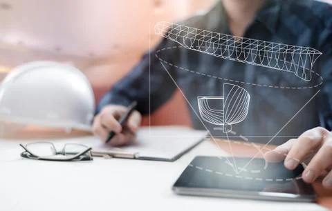 Young blurred sub-designer sitting in the office and designing ship for futur Stock Photos