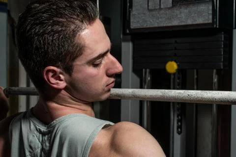 Young body builder doing heavy weight exercise for back Stock Photos