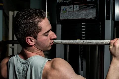 Young body builder doing heavy weight exercise for back Stock Photos