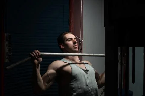 Young body builder doing heavy weight exercise for back Stock Photos