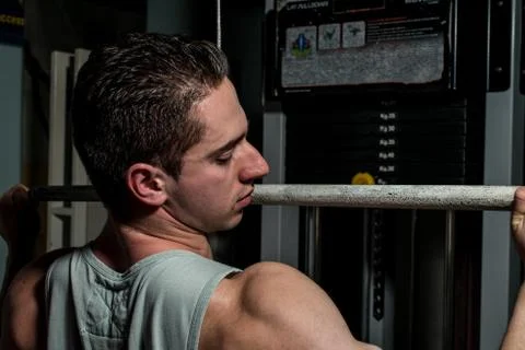 Young body builder doing heavy weight exercise for back Stock Photos