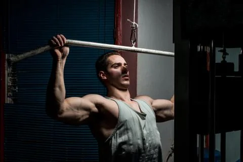 Young body builder doing heavy weight exercise for back Stock Photos