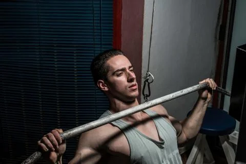 Young body builder doing heavy weight exercise for back Stock Photos