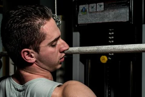Young body builder doing heavy weight exercise for back Stock Photos