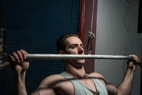 Young body builder doing heavy weight exercise for back Stock Photos