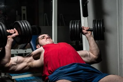 Young bodybuilder doing bench press for chest Stock Photos