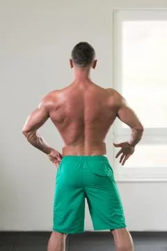 Young Bodybuilder Flexing Muscles Stock Photos