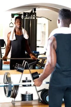 Young bodybuilder lifting the barbell Stock Photos