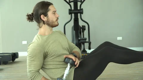 Young bodybuilder man doing sit up and lifting dumbbell exercise strengthen s Stock Footage 147423887