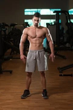Young Bodybuilder Posing In The Gym Stock Photos