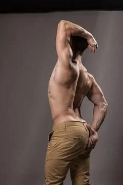 Young bodybuilder rear view, back strong muscular Stock Photos