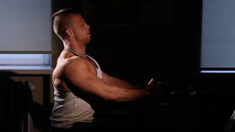 Young bodybuilder training in a gym. 60 to 24fps 4K Stock Footage 74312810