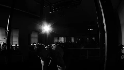 Young bodybuilder training in a gym. Dramatic black and white footage Stock Footage 74313315