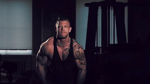 Young bodybuilder training in a gym with dumbbels. 60 to 24fps 4K 動画素材 74338839