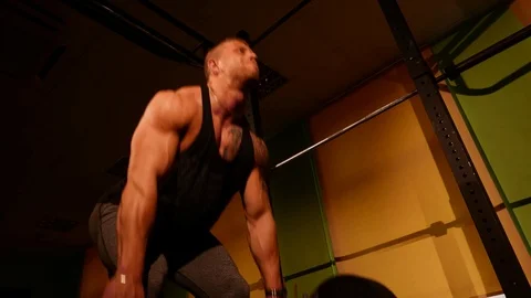 Young bodybuilder training in a gym Stock Footage