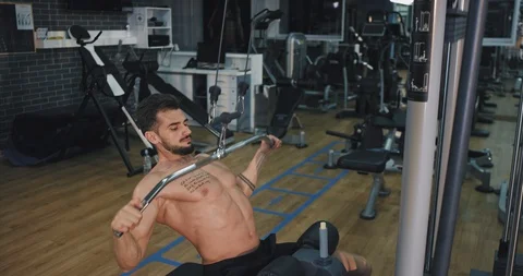 Young bodybuilding man concentrated working on gym class lifting weights Stock Footage 116035387