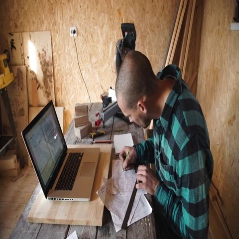 Young bold carpenter with moustache drawing in his workshop Stock Footage 69532791