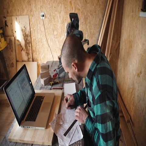 Young bold carpenter with moustache drawing in his workshop Stock Footage 69535389