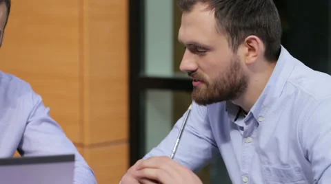 Young boss talking to his colleagues during their business meeting Stock Footage 64112568