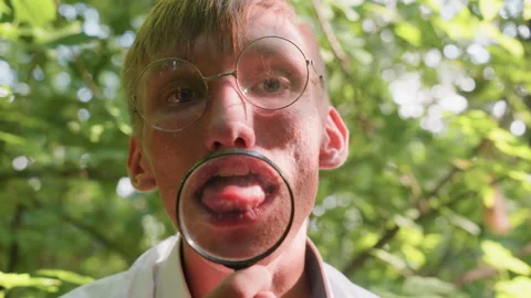 Young Botany Student Holding Microscope Bringing Out Tongue Stock Footage 321109689