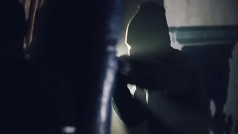 Young Boxer fighter over black background in the underground sport club Stock Footage 73869805