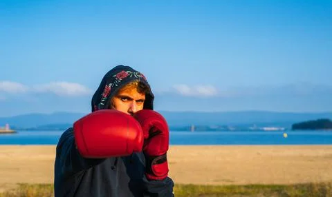 Young boxer posing throwing a punch Stock Photos