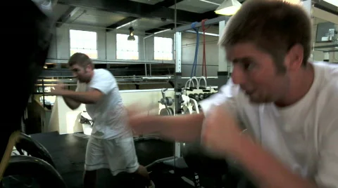 Young boxer punching bag Stock Footage 446167