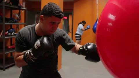 Young Boxer Punching Bag Practicing Inside Gym Stock Footage 214881572