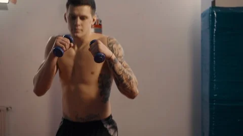 Young boxer with tattoos training in gym, slow motion Stock Footage 101306454