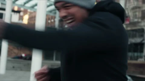 A young boxer throws fast combinations in a city park Stock-Footage 153342072