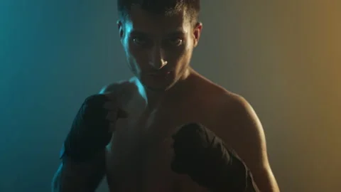 Young Boxer In Training. Handsome Man Looks Straight Into The Camera And Holds Video stock 160762404