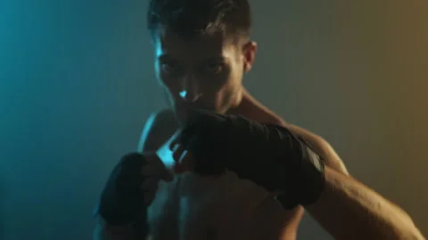 Young Boxer In Training. Handsome Man Looks Straight Into The Camera And Holds Stock-Footage 160808380