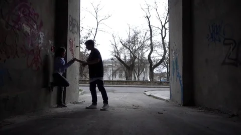 Young Boy and Girl dancing fun on the City Street Arch Gateway - dark Suburb Stock Footage 73923402