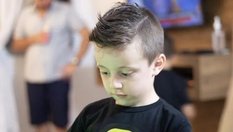 Young boy angry using a black t-shirt and looking to the side Stock-Fotos