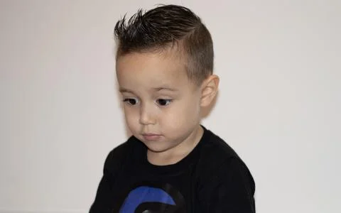 Young boy angry using a black t-shirt and looking to the side t-shirt and loo Stock Photos
