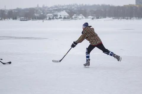 Young boy attacking fast while playing hockey Stock Photos