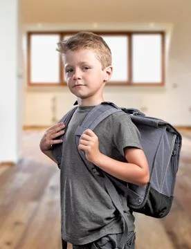 Young boy with backpack isolated on white background Stock Photos