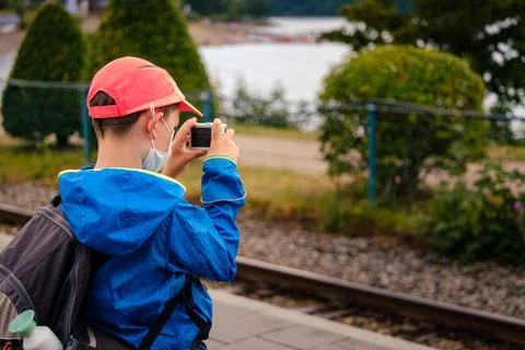 Young boy with backpack taking picture Stock Photos