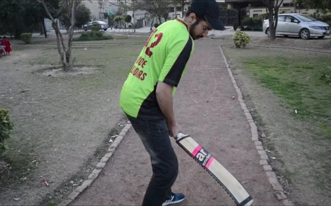 A young boy batting in a ground. Person Playing cricketing with bat Stock Footage 237399708