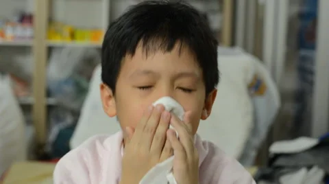 Young boy blows his nose Stock Footage 48725555