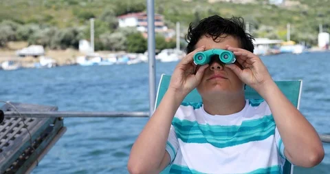 Young boy on boat looking through binoculars 3 Stock Footage 109470989