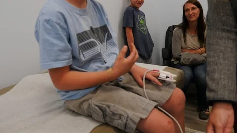 Young boy with a broken hand in the doctors office Stock Footage 118581379