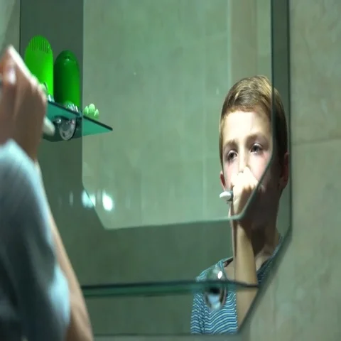 Young boy brushing teeth in bathroom Stock Footage 69631075