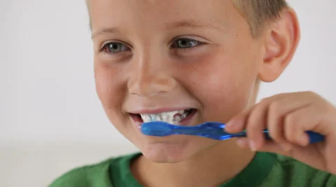 Young boy brushing teeth | Stock Video | Pond5