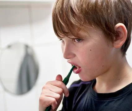 Young boy brushing teeth Stock Photos