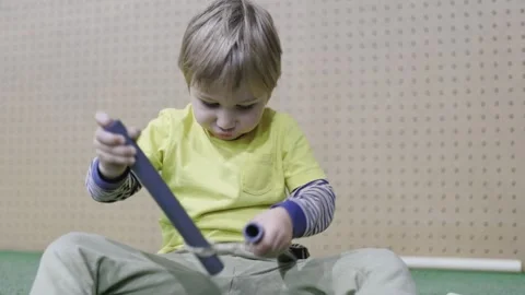 Young boy building and playing with tubes Stock Footage 317817900