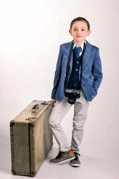 Young boy with camera and suitcase Stock Photos