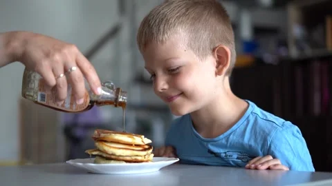 A young boy can't wait for eating pancakes Stock Footage 220631858