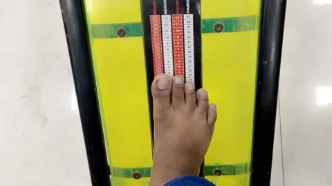 A young boy is checking his feet size in shoe sizes chart concept HD(4k) Stock Footage 221723971